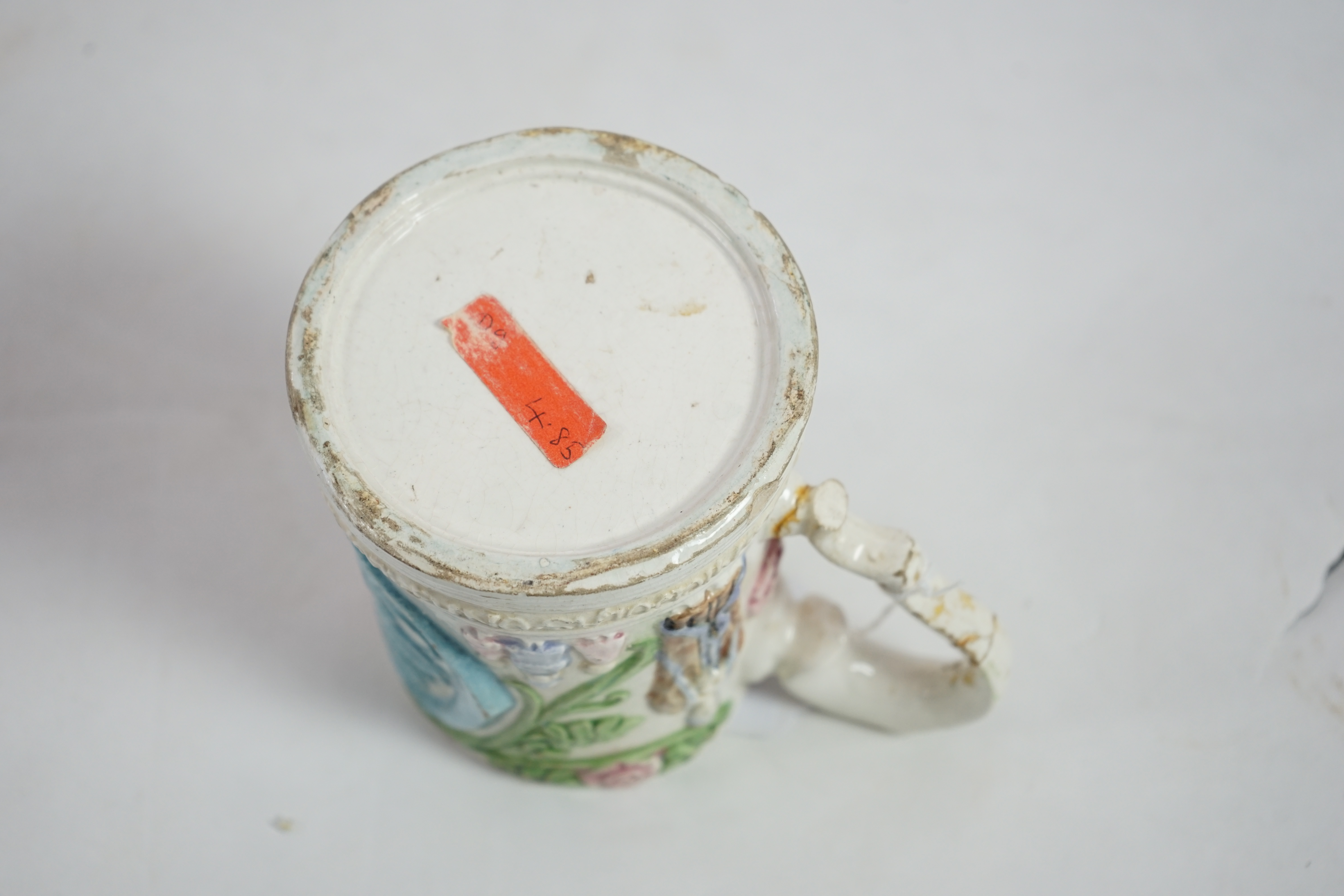 A Compton pottery mug, decorated with St Nicholas on a pilgrimage, 12cm high. Condition - poor